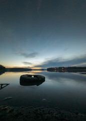 sunset over the lake, tire in the lake 