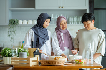 Cute Girl and Son and Her Muslim Mom In Hijab Preparing Pastry For Cookies In Kitchen, Baking Together At Home. Islamic Lady With Daughter and son Enjoying Doing Homemade Pastry