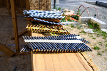 Stacks of framing nails sitting on the windowsill of a house under construction in a new...