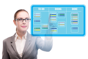 Businesswoman working on kanban board with tasks