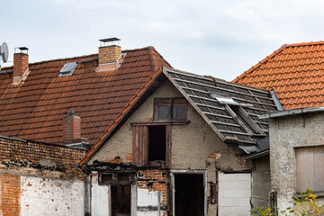 Ruined building in a German town. The abandoned house is very old and in bad condition. The windows...