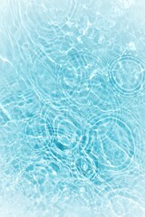 Fototapeta na wymiar Defocus blurred transparent blue colored clear calm water surface texture with splashes reflection. Trendy abstract nature background. Water waves in sunlight with copy space. Blue watercolor shine.