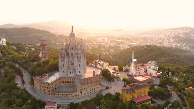 Sunrise over Tibidabo, Barcelona aerial view showcasing the Expiatory Church of the Sacred Heart of Jesus, Spain