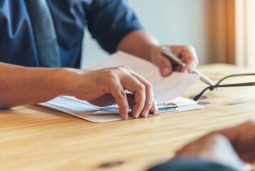 Businessman hands note meeting document in conference room. man Hands writing planning notebook. Close up male hand holding pencil write on diary sketchbook at office desk. Business Planning Concept