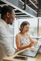 Business professionals collaborate in a modern office for efficient project discussions and idea...