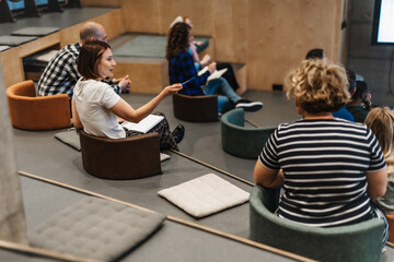 Business professionals gathered in the conference room for a meeting to discuss strategies and solutions to their company's current challenges.