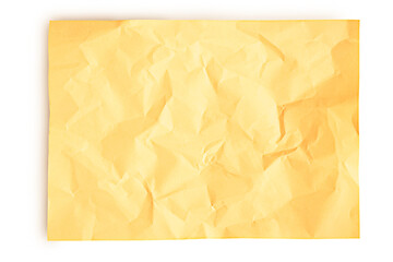 Yellow slightly crumpled sheet of paper isolated on white background with soft shadow. Blank paper.