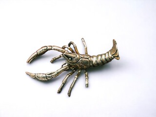 Miniature statue of a gold lobster on a white background