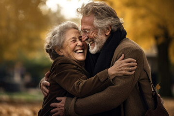 Portrait of an elderly couple together. Happy senior couple in autumn park.