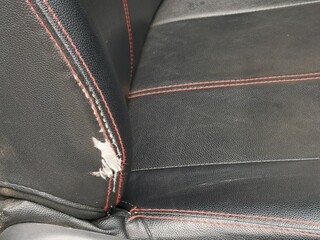 Ripped car seat with visible foam. - obrazy, fototapety, plakaty