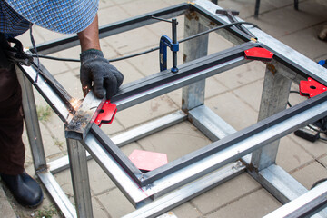 worker  welds the steel structure at the construction site.