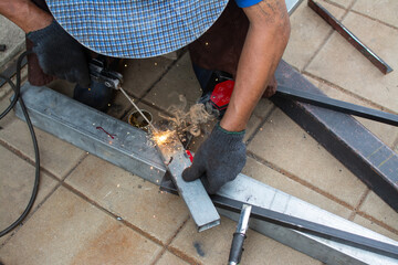worker  welds the steel structure at the construction site.