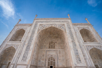 Fototapeta na wymiar Side view of the Taj Mahal's white domes and white towers at sunset. The Taj Mahal is a treasure of Indian Muslim art. UNESCO World Heritage Site.