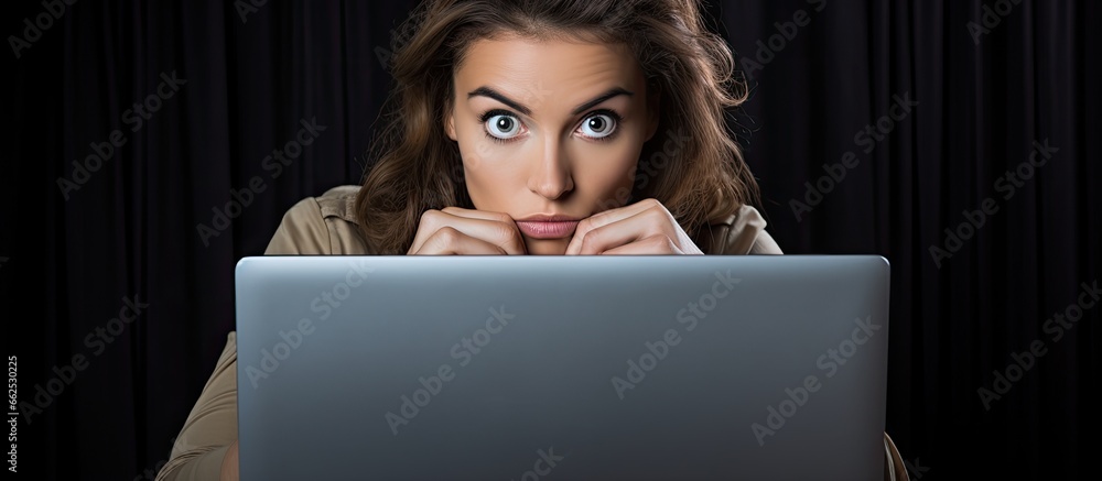 Poster office worker concerned about internet security while safeguarding her laptop screen with copyspace 