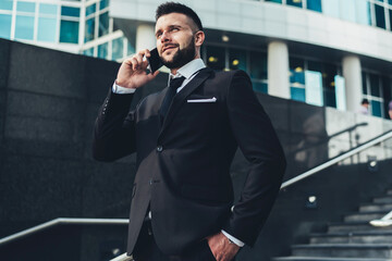 Businessman talking on phone in city center