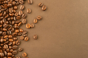 Coffee beans on brown background isolated