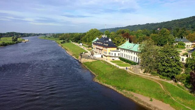 Drone shot, drone flight, from Pillnitz Palace over the Elbe River, camera pan over the Elbe ferry to the Elbe valley and view to Dresden, in sunlight, Saxony, Germany, Europe