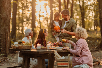 Family having a picnic in the forest in fall