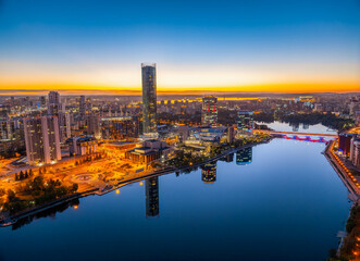 Yekaterinburg city and pond aerial panoramic view at summer or early autumn night. Night city in the early autumn or summer.