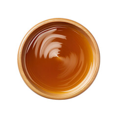 Top view of caramel sauce dip in a wooden bowl isolated on a white background