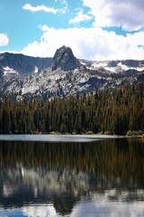 a vertical shot of the mammoth lakes with rocky mountains and forest on the background, CA