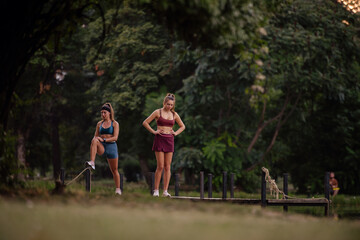 Fit Females Engaging in Athletic Training and Stretching Outdoors in a Beautiful Park Environment