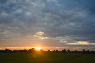 sunset autumn landscape with an old hut