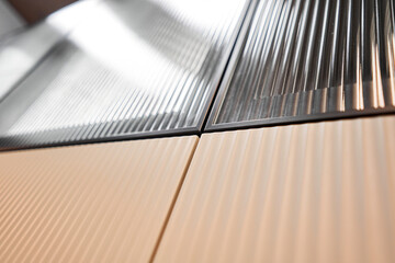 Beige kitchen cabinets with wavy texture. Glass inserts. Push mechanism, without handles on the doors