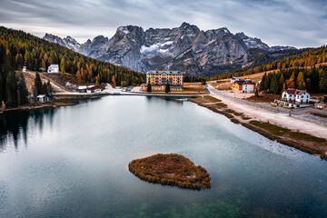 Misurina, Italy - Aerial view of Cristallo mountains of the Italian Dolomites at Lake Misurina in South Tyrol with morning autumn lights, cloudy sky