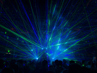 Fototapeta na wymiar A view of a live show using green and blue colored lasers.