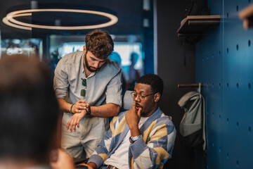 Multiracial businesspeople in a modern office work on market research, networking, and stock market analysis for profitable partnerships and growth. Employee checking time on watch. Deadline concept.