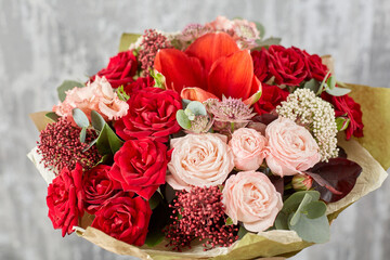 Small Beautiful bouquet of mixed flowers in woman hand. Floral shop concept . Beautiful fresh cut bouquet. Flowers delivery