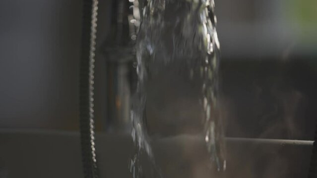 Hot running water from tap with steam