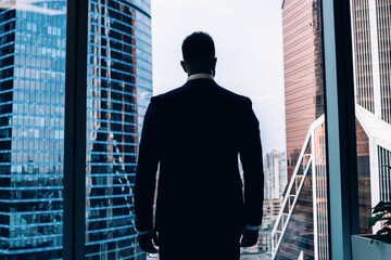 Fototapeta premium Confident male manager standing at window in office