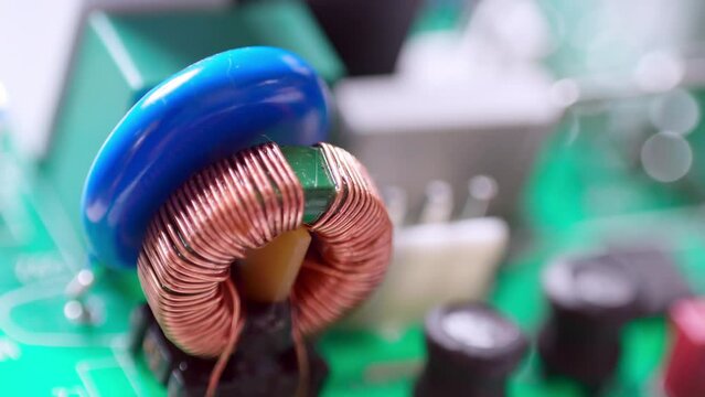 A close-up of a conductor on a circuit board, and slowly zooming out of it to see the rest of the parts.