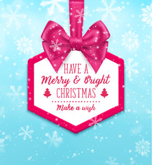 Christmas frame with pink bow. Vector hexagon border with glossy ribbon and festive wishes. Tag hanging on blue background with falling snowflakes. Holiday badge with seasonal wishes and warm greeting
