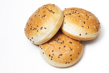 Burger buns isolated on white. Fastfood background. Hamburger bread rolls. Three sweet baked hamburger rolls on white table.