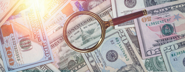 USD Hundred dollar banknote with magnifying glass as finance background