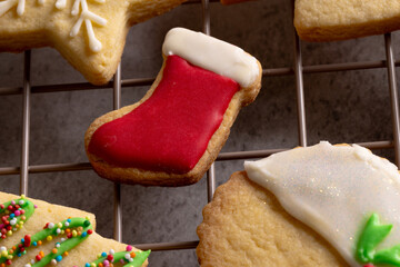 Close up of decorated christmas cookies with copy space on grey background