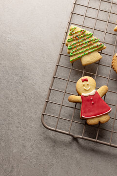 Vertical image of decorated christmas cookies with copy space on grey background