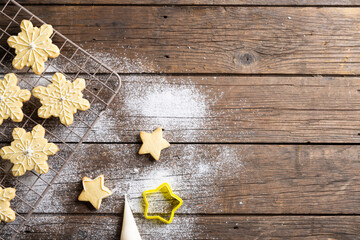 Close up of christmas cookies with flour and copy space on wooden background