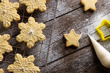 Close up of christmas cookies with flour and copy space on wooden background
