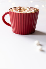 Vertical image of red christmas mug of chocolate and marshmallows with copy space