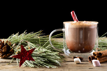Glass mug of chocolate and marshmallows and christmas decorations with copy space