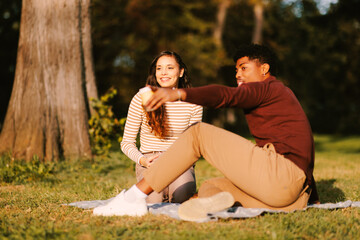 Young happy couple enjoying in the park during autumn day