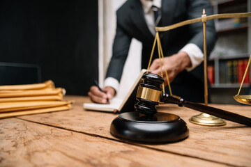 Business and lawyers discussing contract papers with brass scale on desk in office. Law, legal services, advice,  justice and law concept . in office..