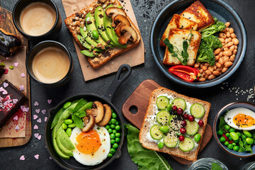 Tasty food with avocado toast, vegetables, eggs on dark background. Helthy breakfast concept - obrazy, fototapety, plakaty