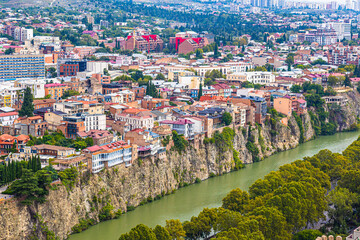 Colored houses standing on a steep cliff in Tbilis, Georgia