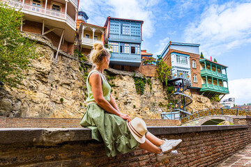 Girl traveler enjoys magnificent view of fig gorge in Tbilisi, Georgia