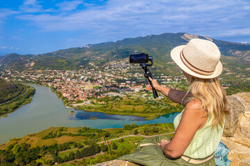 The traveler has a picturesque view of the city of Mtskheta and the confluence of two rivers in Georgia.